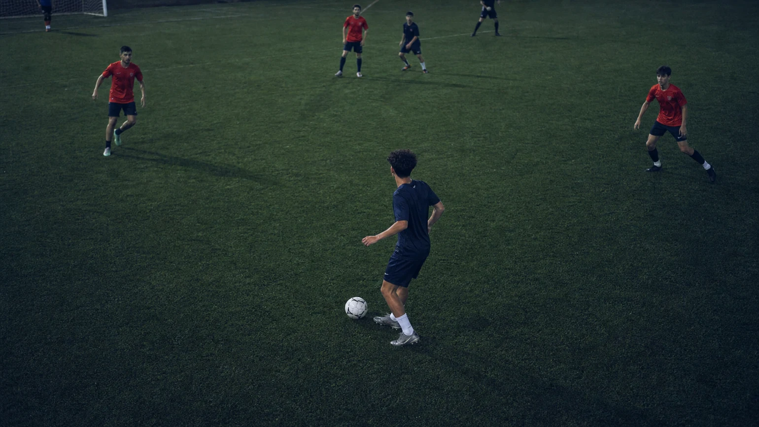 a player receiving with his head up, three open passing lanes readable around him